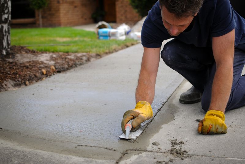 A concrete footpath being laid by a concreter