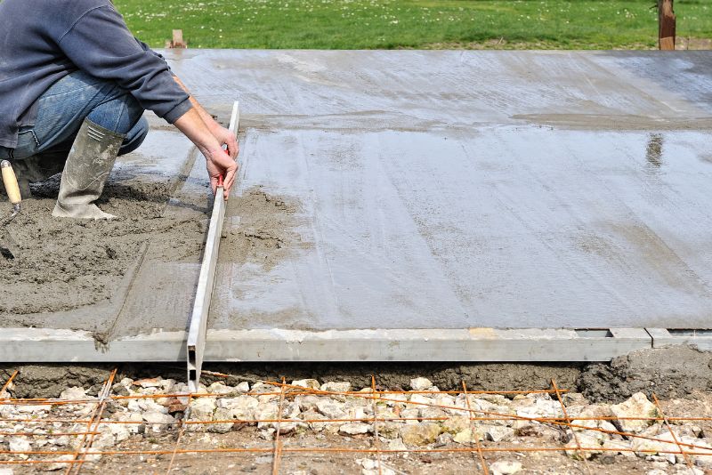 A photo of a man levelling a concrete slab