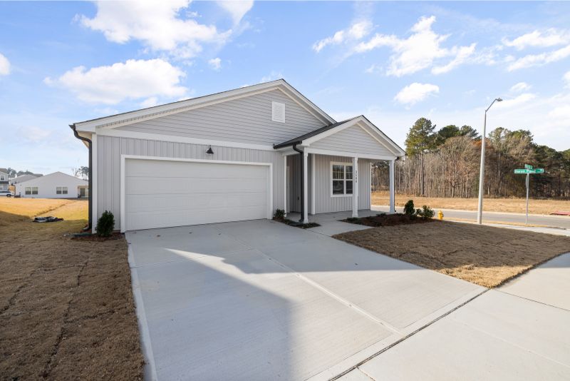 A concrete driveway leading up to a house
