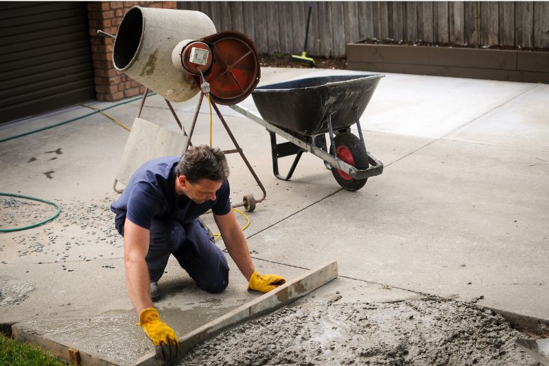 A concrete contractor pouring concrete on a commercial property